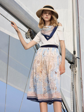 a lady in map printed midi skirt with white top